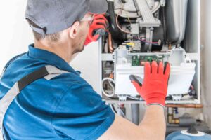 Haining Home Services technician installing a new furnace.