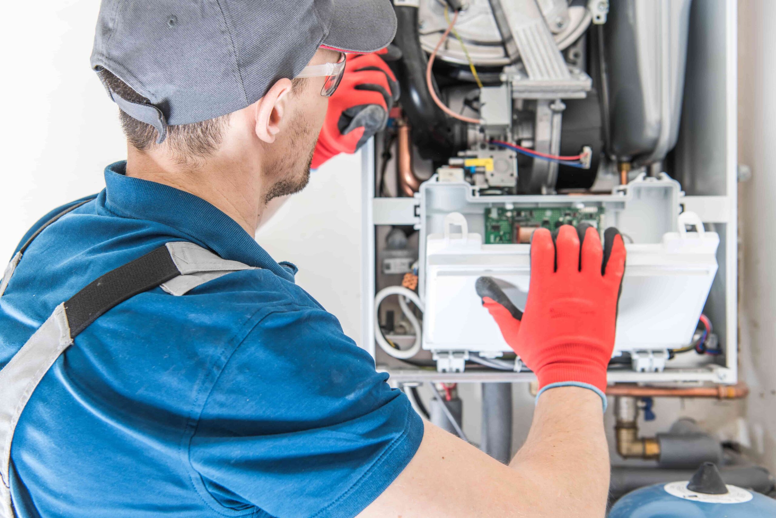 Haining Home Services technician installing a new furnace.